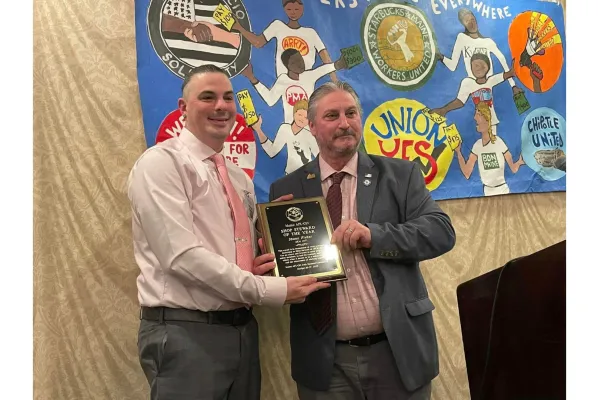Chief Steward Shaun Fisher (left - IBEW Local 2071) receives the 2023 Steward of the Year Award